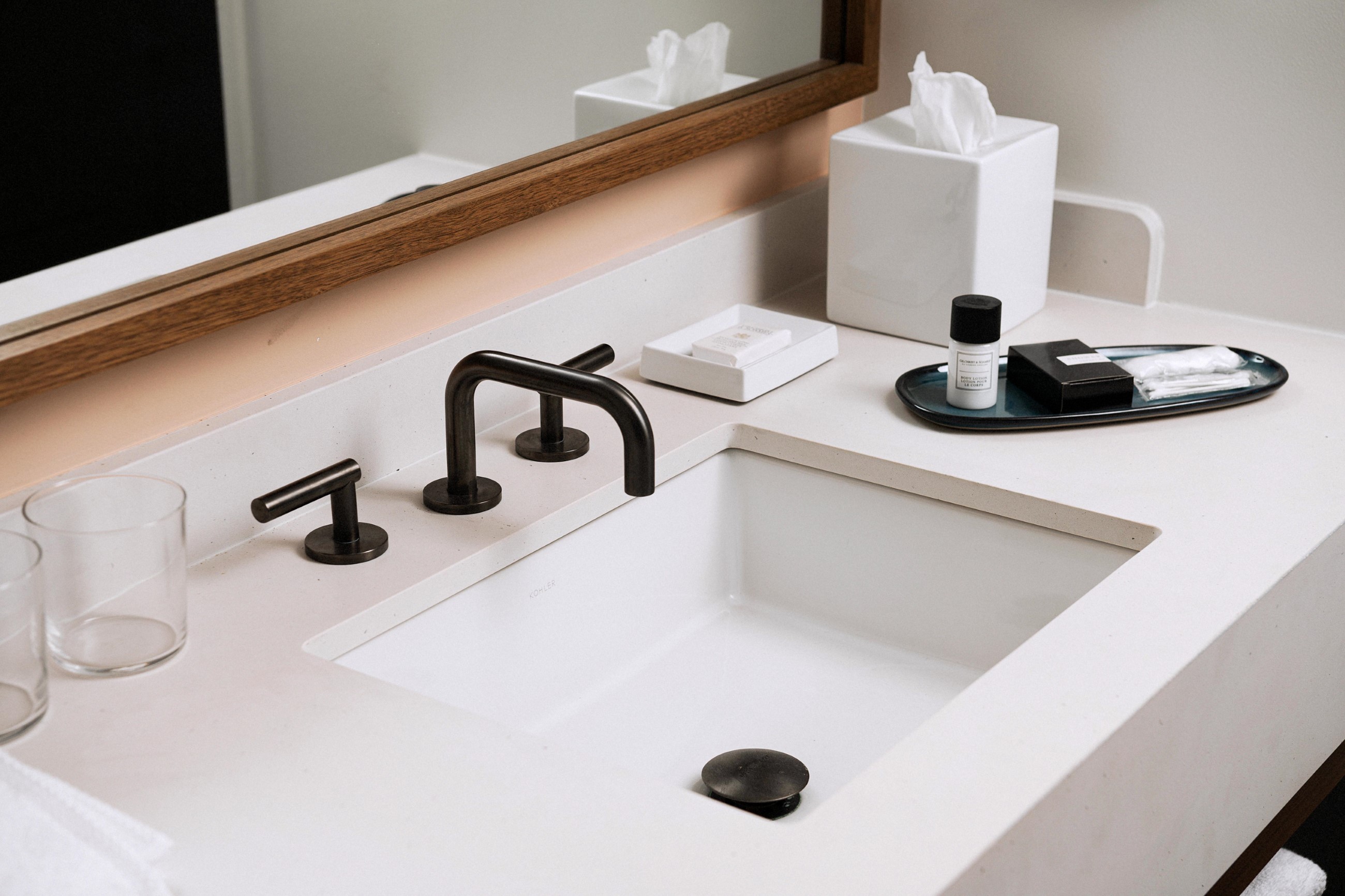 Bathroom sink and mirror on the wall in a guest room