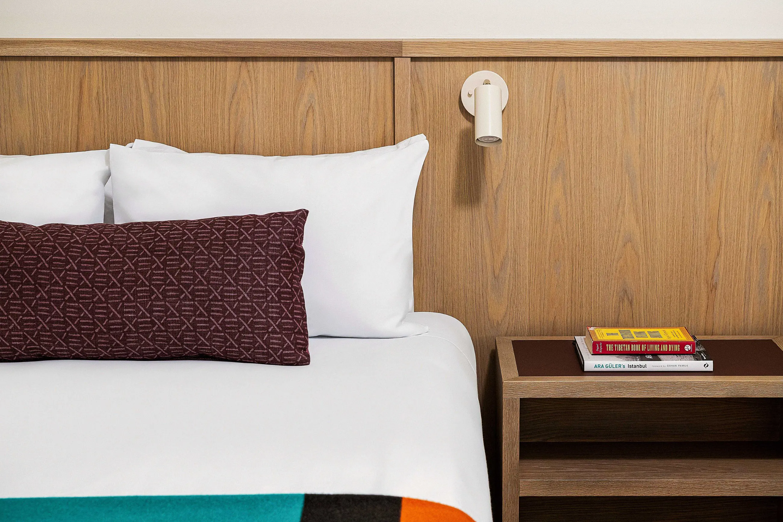Queen bed with books on the side table