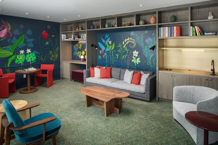 Seating area with flowers painted on the wall